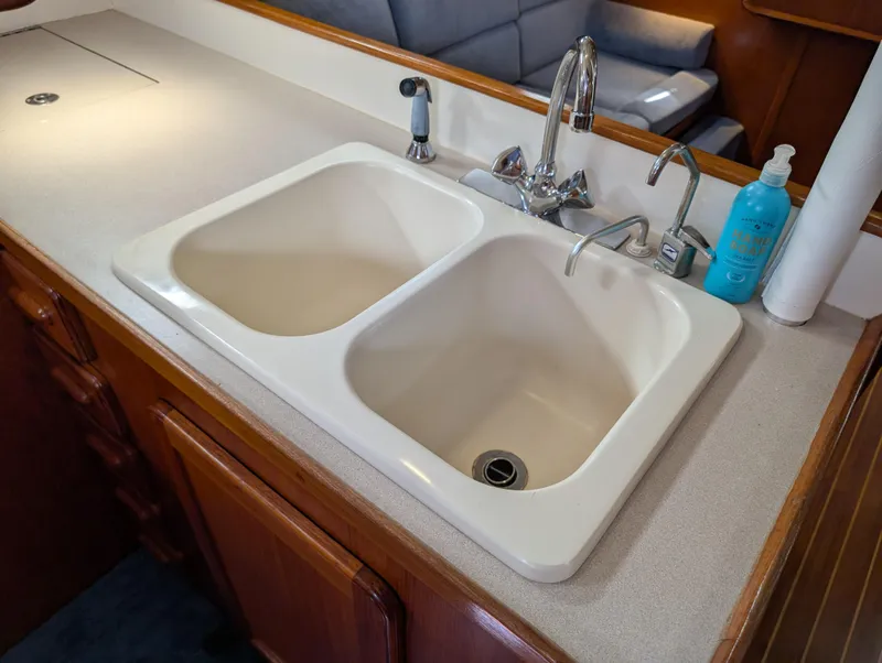 Slide: The Image of Double sink in a 1998 Caliber 40 LRC yacht kitchen with faucet and soap dispenser. - 17