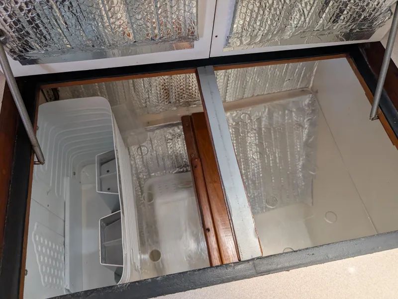 Slide: The Image of Interior view of a 1998 Caliber 40 LRC yacht storage compartment with insulation. - 18