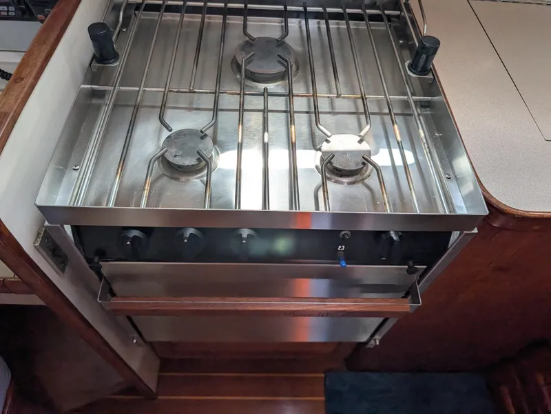 Slide: The Image of Stainless steel three-burner stove and oven in a 1998 Caliber 40 LRC yacht kitchen. - 19