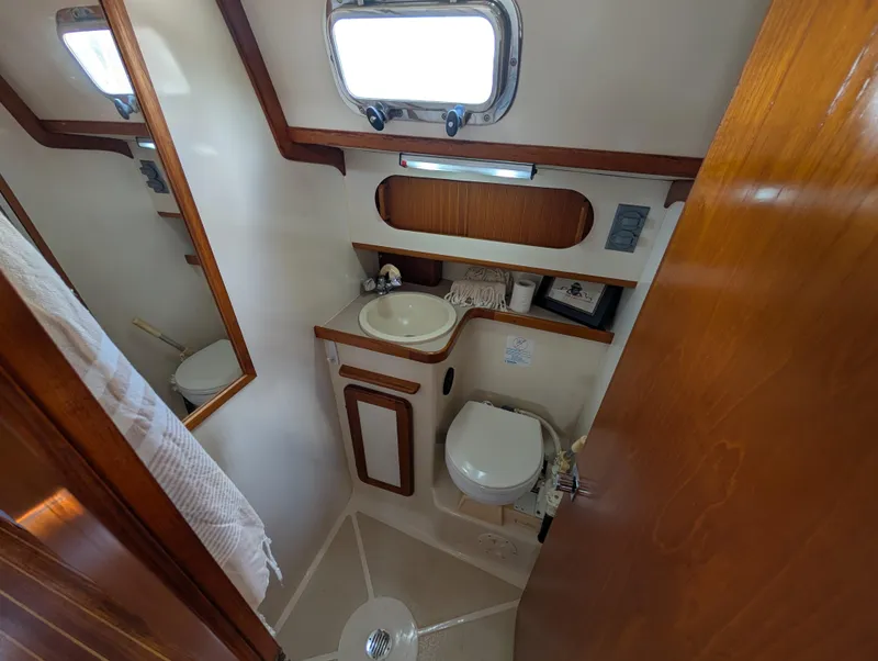 Slide: The Image of Compact bathroom in 1998 Caliber 40 LRC yacht with sink, toilet, and mirror. - 30