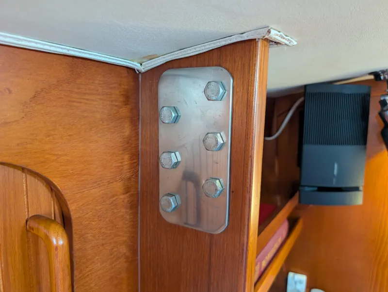 Slide: The Image of Interior of 1998 Caliber 40 LRC yacht showing metal bracket on wooden panel. - 31