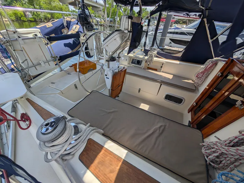 Slide: The Image of 1998 Caliber 40 LRC sailboat cockpit with steering wheel, seating, and nautical equipment. - 33
