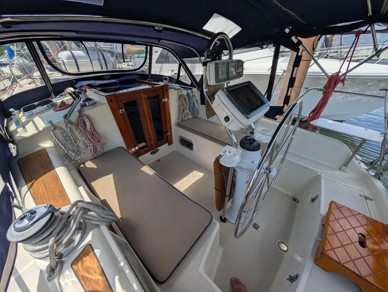 Slide: The Image of 1998 Caliber 40 LRC sailboat cockpit with steering wheel, navigation equipment, and seating area. - 35