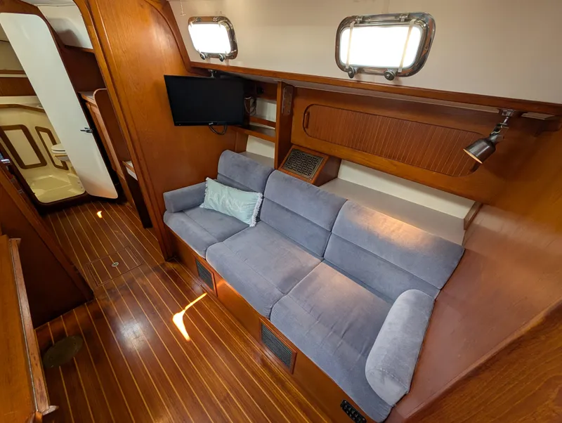 Slide: The Image of Interior of 1998 Caliber 40 LRC yacht with cozy seating and wooden finishes. - 4