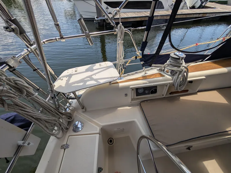 Slide: The Image of Sailboat cockpit of 1998 Caliber 40 LRC, featuring ropes and seating, docked at marina. - 40
