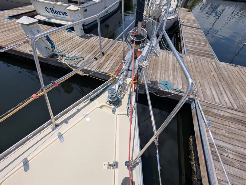 Slide: The Image of Sailboat Caliber 40 LRC, 1998 model, docked at marina with wooden walkways. - 46