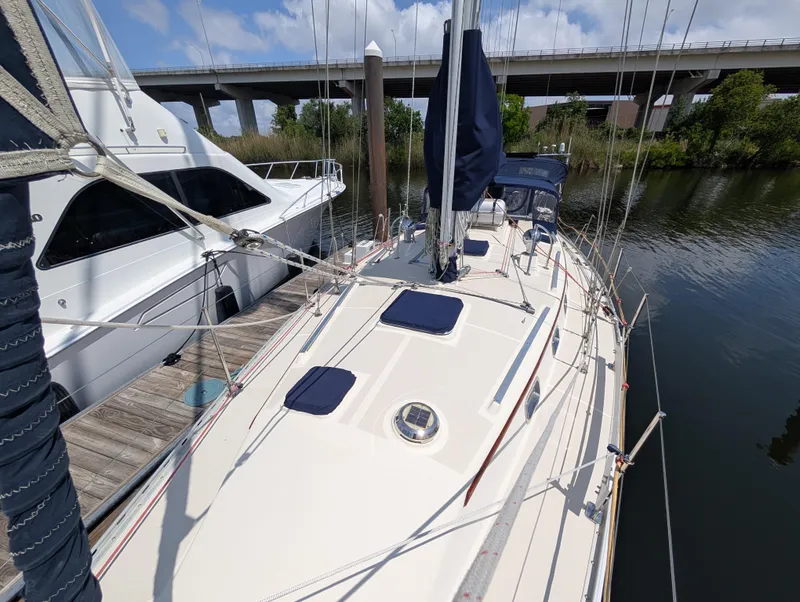 Slide: The Image of Sailboat Caliber 40 LRC 1998 docked near a bridge on a sunny day. - 49