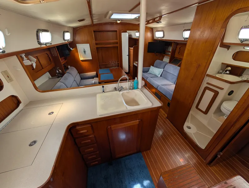 Slide: The Image of Spacious 1998 Caliber 40 LRC yacht interior with wood finish, kitchen, and seating area. - 6