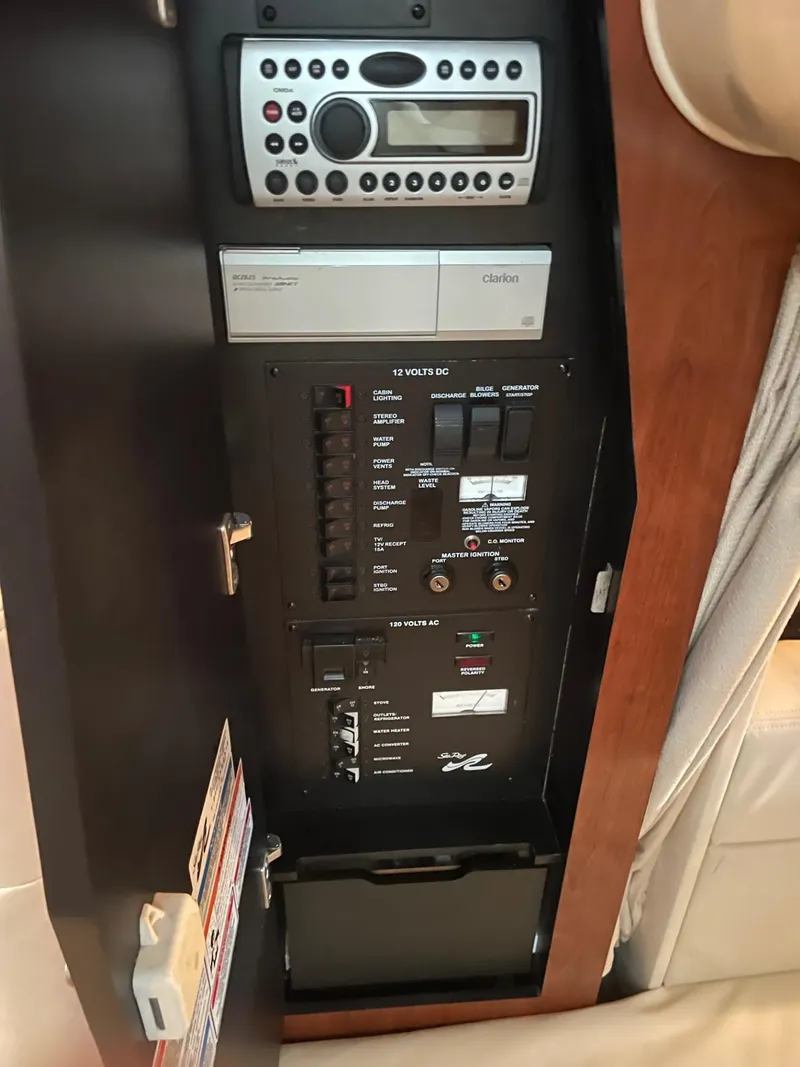 Slide: The Image of Control panel of a 2007 Sea Ray 320 Sundancer boat, featuring audio and electrical systems. - 10