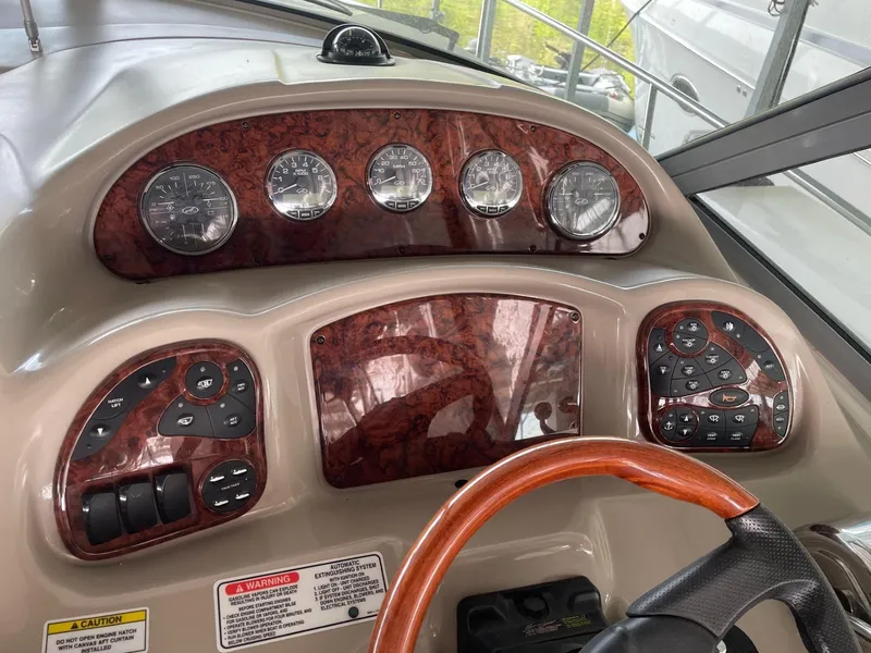 Slide: The Image of Helm dashboard of 2007 Sea Ray 320 Sundancer with wood accents and gauges. - 11