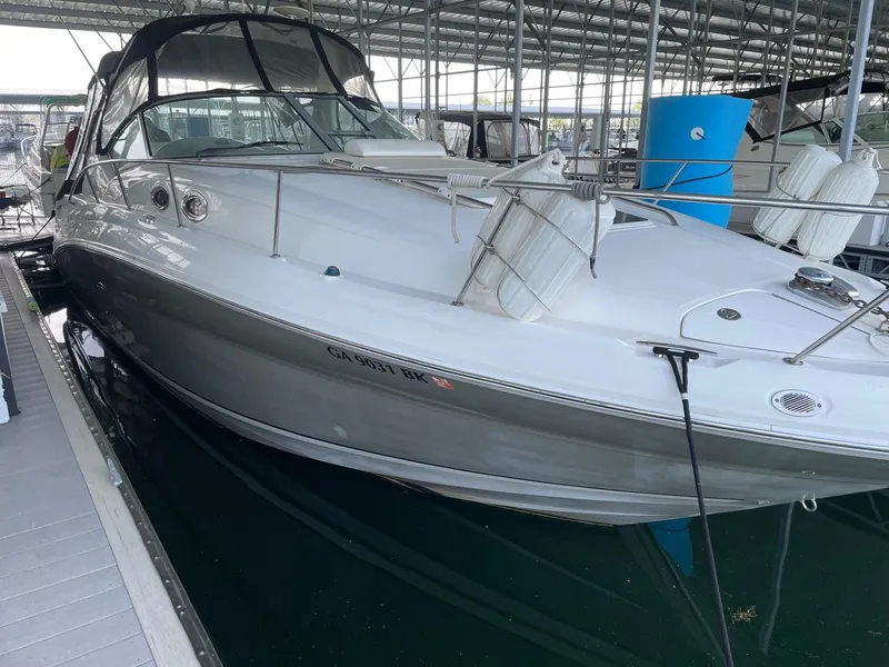 Slide: The Image of 2007 Sea Ray 320 Sundancer docked in a covered marina. - 2