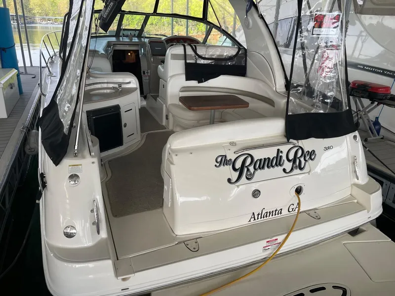 Slide: The Image of 2007 Sea Ray 320 Sundancer boat docked, featuring spacious seating and elegant design. - 4