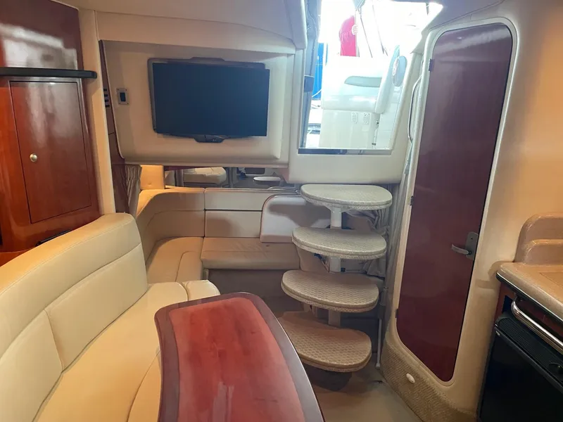 Slide: The Image of Interior of 2007 Sea Ray 320 Sundancer yacht with seating, TV, and stairs. - 8