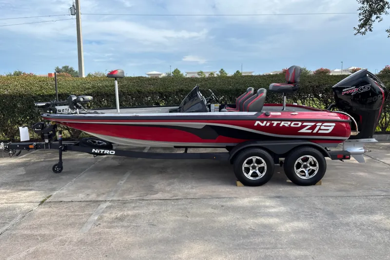 The Image of 2025 Nitro Z19 Pro bass boat with red and black design on a trailer. - 0