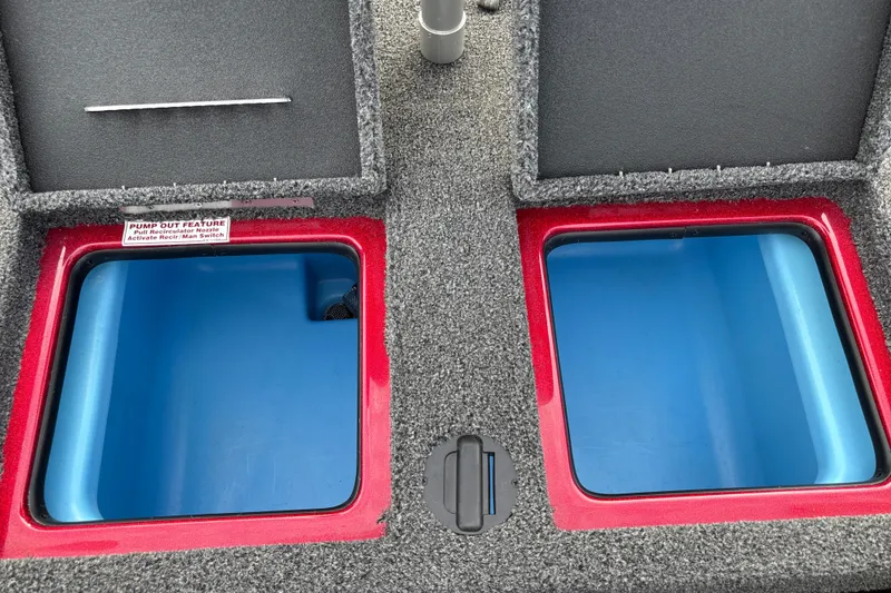 Slide: The Image of Two open storage compartments with blue interiors on a gray boat. - 23