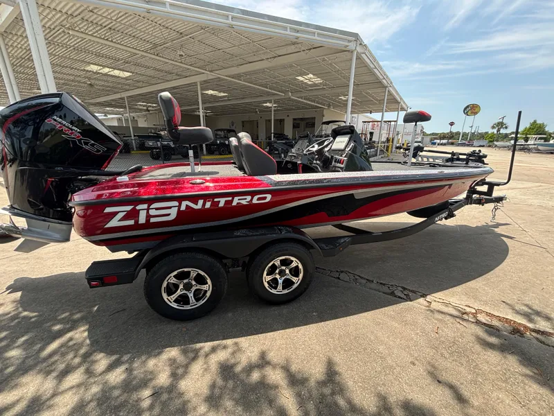 Slide: The Image of 2025 Nitro Z19 Pro boat in red, parked on a trailer under a canopy. - 3