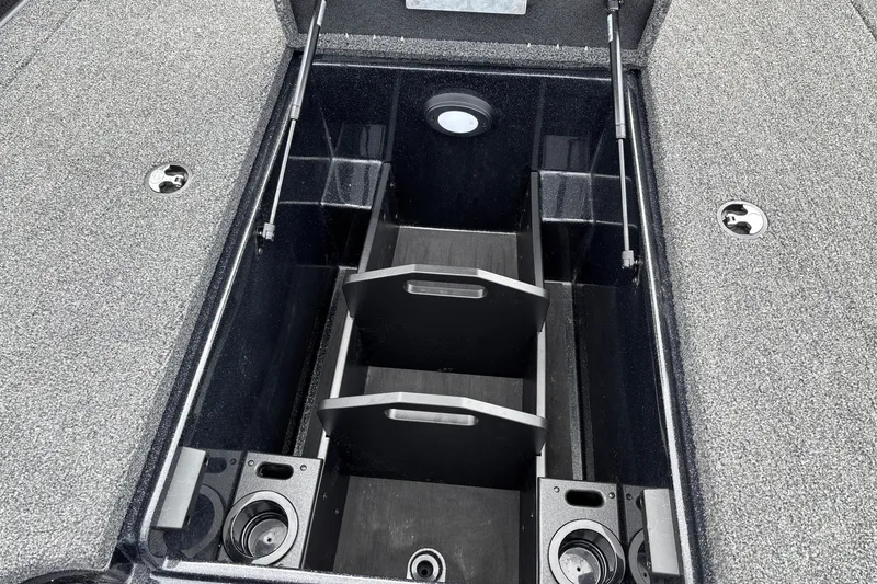 Slide: The Image of Storage compartment of 2025 Nitro Z19 Pro boat with organized dividers and cup holders. - 26