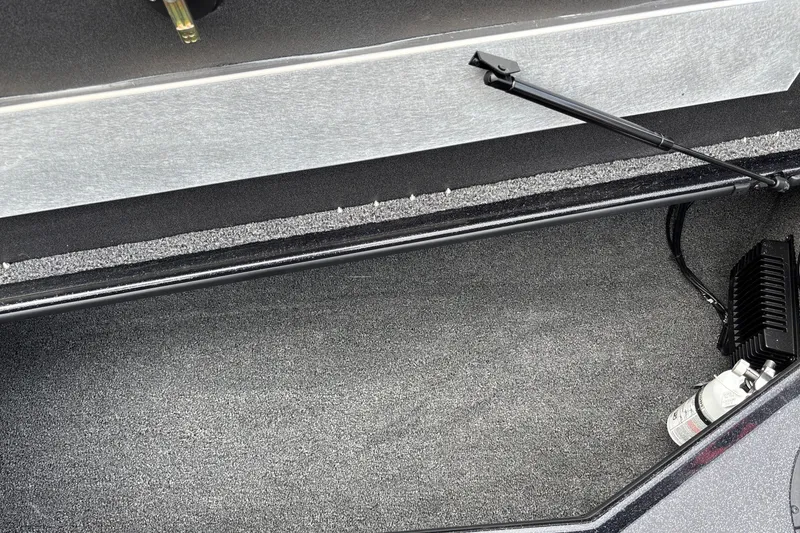 Slide: The Image of Storage compartment of 2025 Nitro Z19 Pro boat with carpeted interior and hydraulic support. - 27