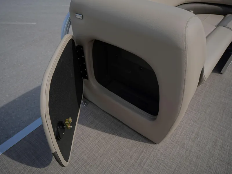 Slide: The Image of 2025 Sun Tracker Party Barge 18 DLX storage compartment with open door. - 10