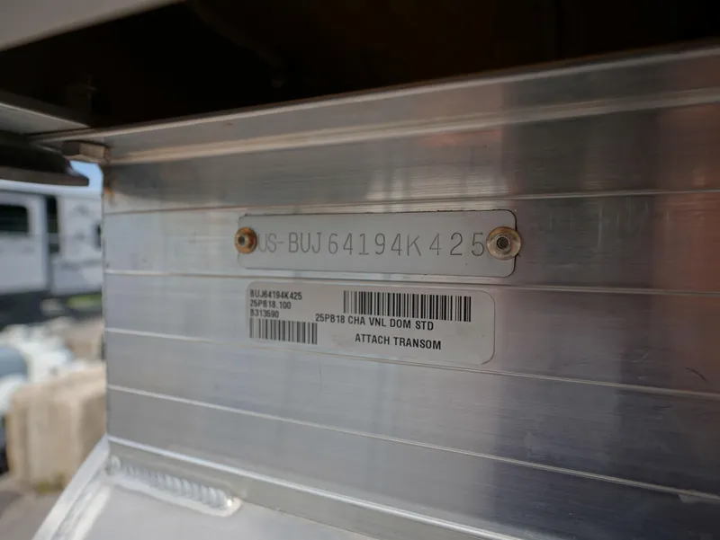 Slide: The Image of 2025 Sun Tracker Party Barge 18 DLX identification plate on aluminum transom. - 13