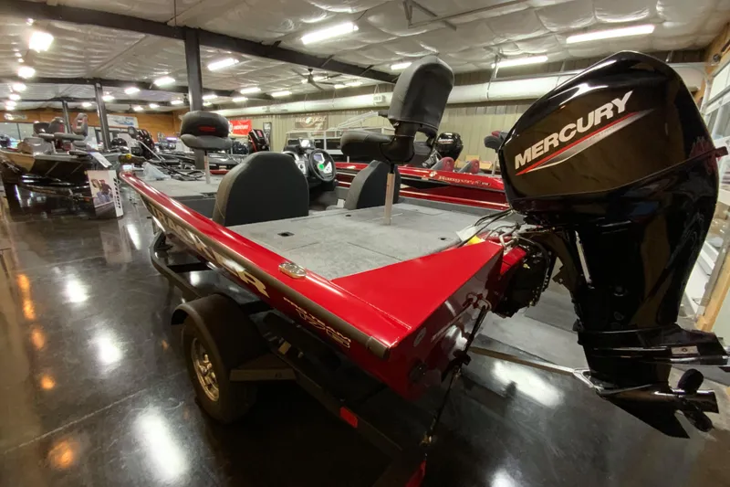 Slide: The Image of 2025 Tracker Pro Team 175 boat with Mercury engine in showroom. - 2