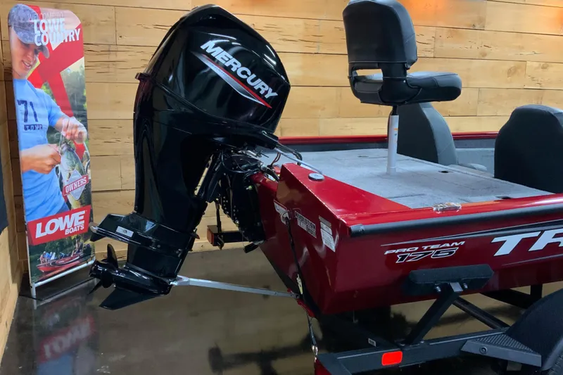 Slide: The Image of 2025 Tracker Pro Team 175 boat with Mercury outboard motor in showroom. - 3