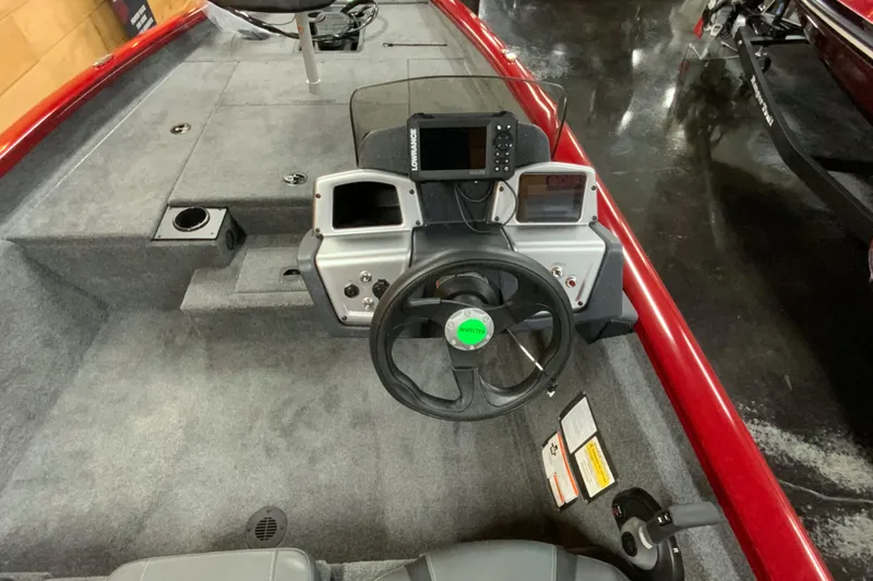 Slide: The Image of 2025 Tracker Pro Team 175 boat interior with steering wheel and navigation equipment. - 5