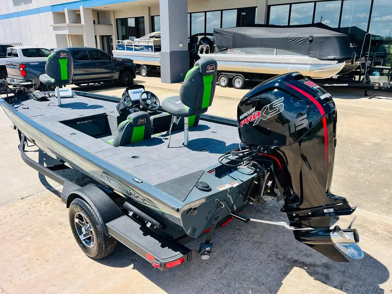 Slide: The Image of 2025 Ranger RT188C boat with motor, parked on trailer, outdoor dealership setting. - 12