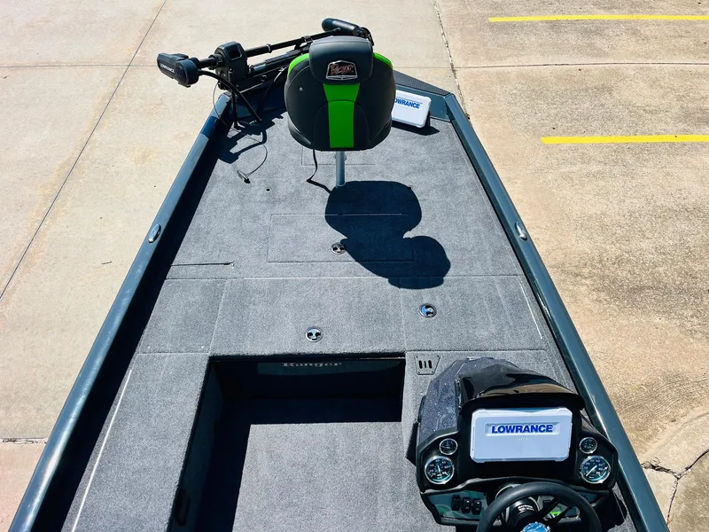 Slide: The Image of 2025 Ranger RT188C boat deck with Lowrance electronics and green-accented seat. - 15