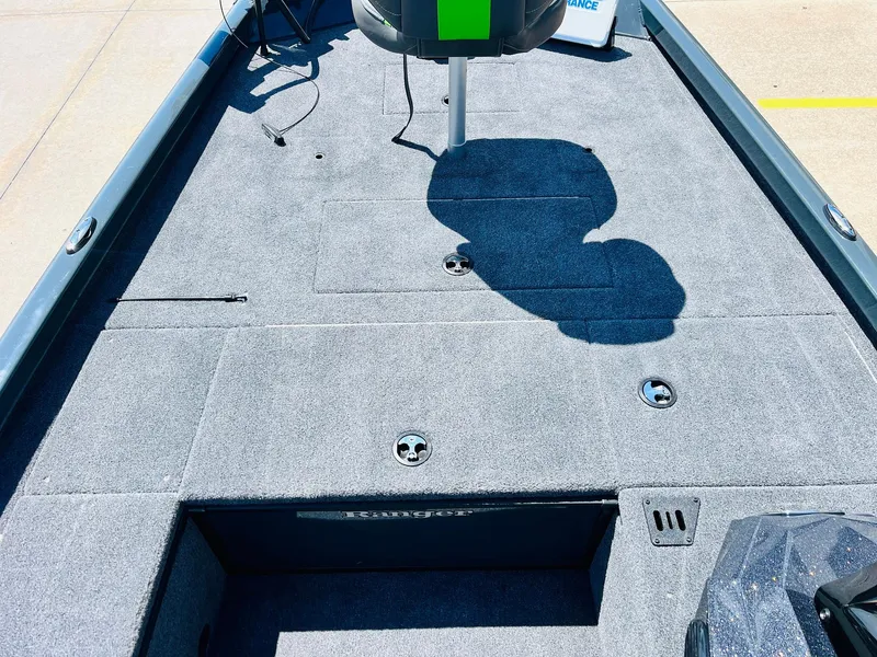 Slide: The Image of 2025 Ranger RT188C boat deck with gray carpet and storage compartments. - 20