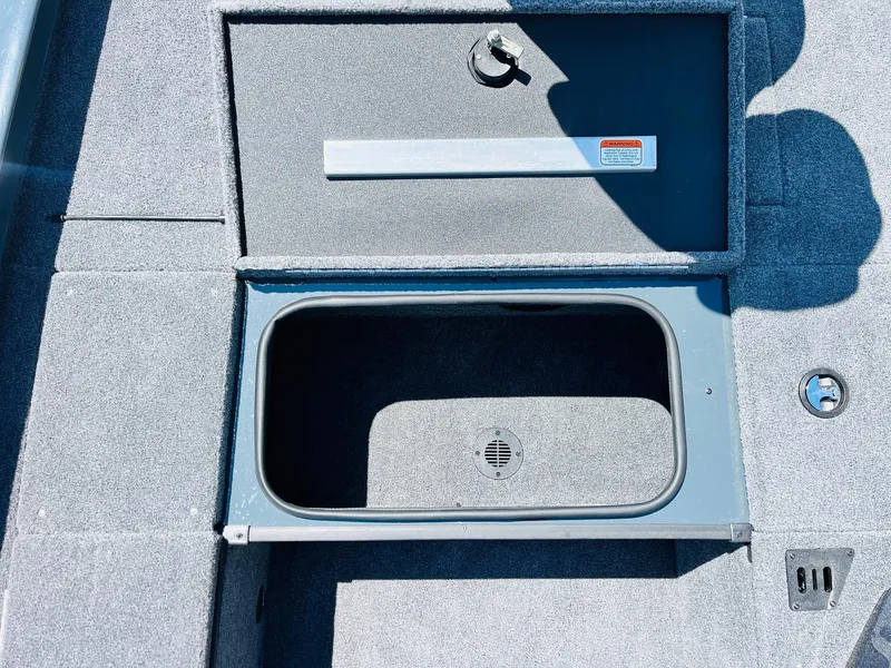 Slide: The Image of 2025 Ranger RT188C boat storage compartment with open lid, showcasing interior space. - 24