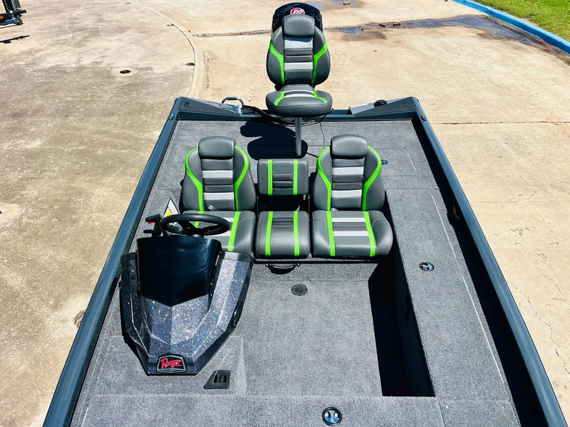 Slide: The Image of 2025 Ranger RT188C boat interior with gray and green seating, steering console, and spacious deck. - 28