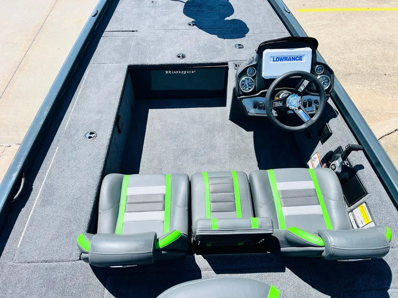 Slide: The Image of 2025 Ranger RT188C boat interior with green-accented seats and Lowrance navigation system. - 30