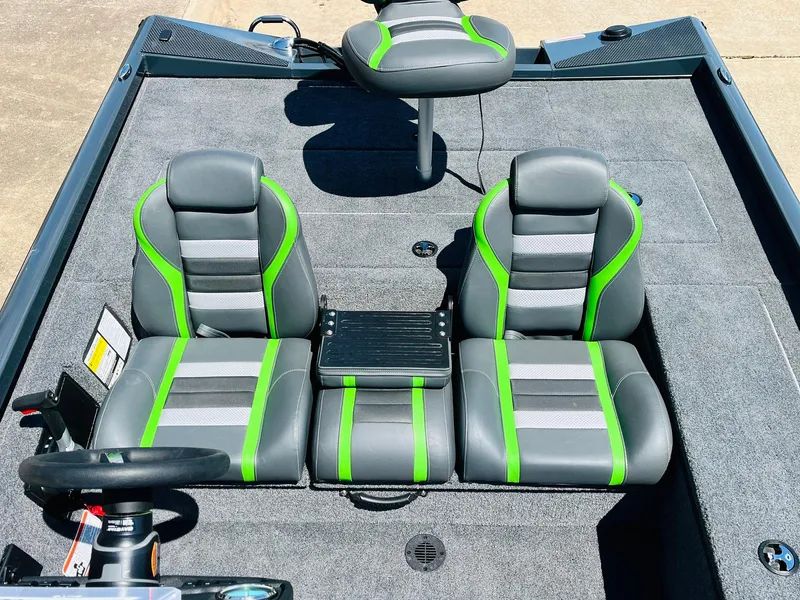 Slide: The Image of 2025 Ranger RT188C boat interior with gray and green seats, steering wheel, and carpeted floor. - 36