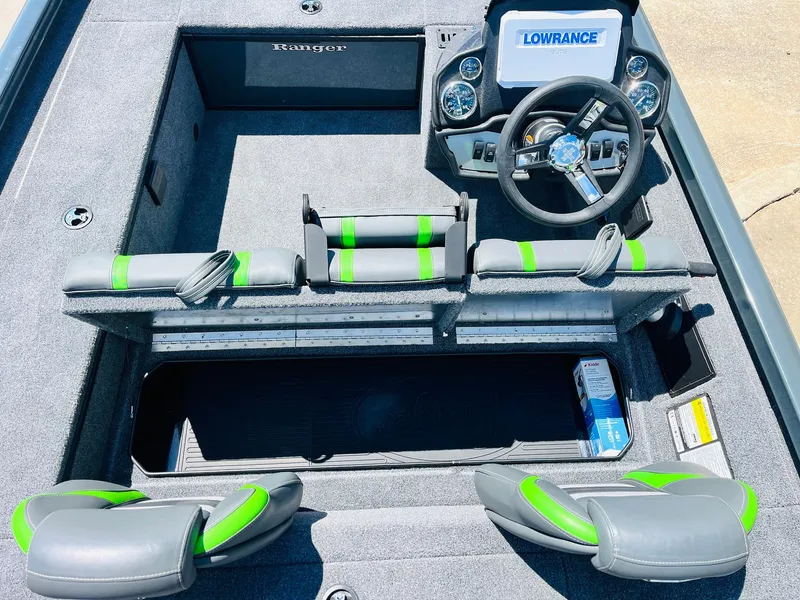 Slide: The Image of 2025 Ranger RT188C boat interior with Lowrance electronics and green-accented seating. - 38
