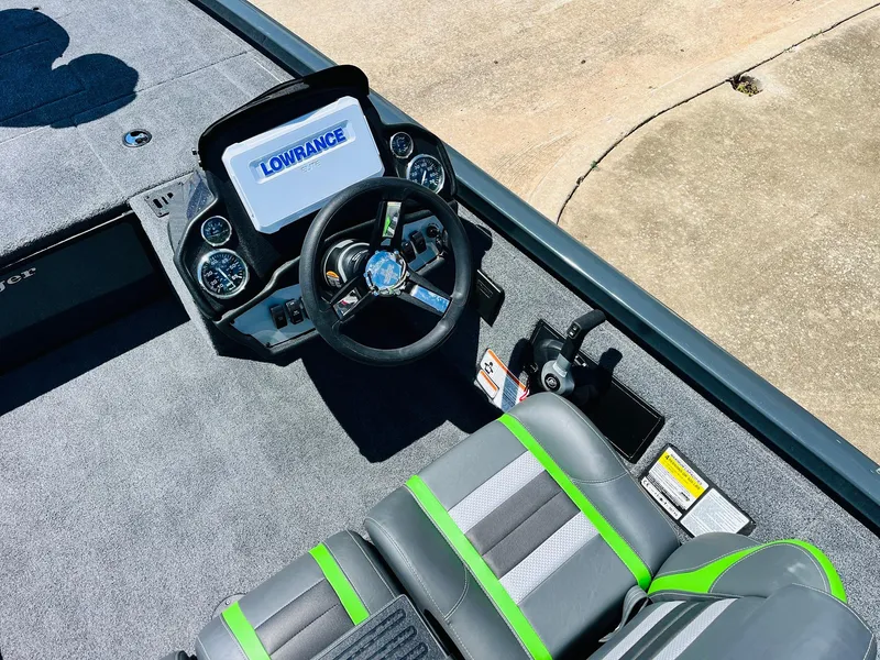 Slide: The Image of 2025 Ranger RT188C boat cockpit with Lowrance display, steering wheel, and gray-green seating. - 41