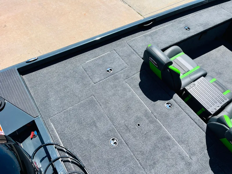 Slide: The Image of 2025 Ranger RT188C boat interior with gray carpet and green-accented seating. - 49