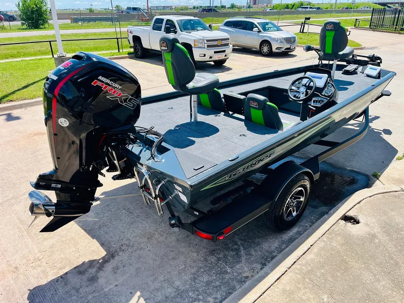Slide: The Image of 2025 Ranger RT188C fishing boat with Mercury outboard motor, parked outdoors. - 8