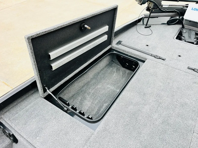 Slide: The Image of 2024 Ranger RT198P boat storage compartment with open lid, showcasing spacious interior. - 12