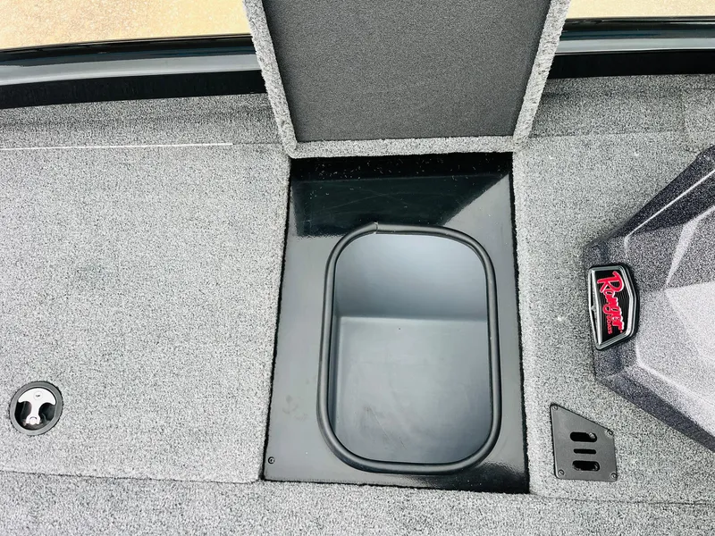 Slide: The Image of 2024 Ranger RT198P boat storage compartment with textured flooring and branded detail. - 19