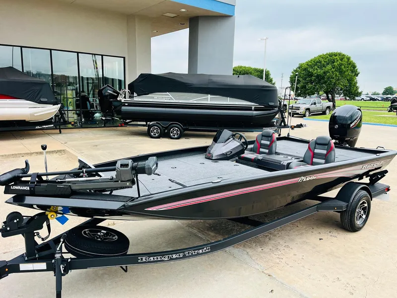 Slide: The Image of 2024 Ranger RT198P fishing boat displayed outdoors, featuring sleek design and modern equipment. - 2