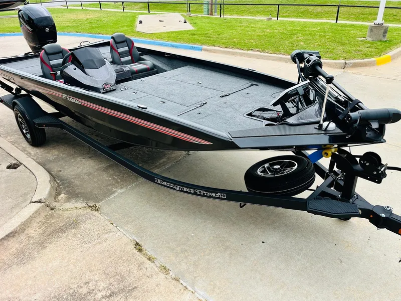 Slide: The Image of 2024 Ranger RT198P boat on trailer, sleek black design, parked on concrete surface. - 3