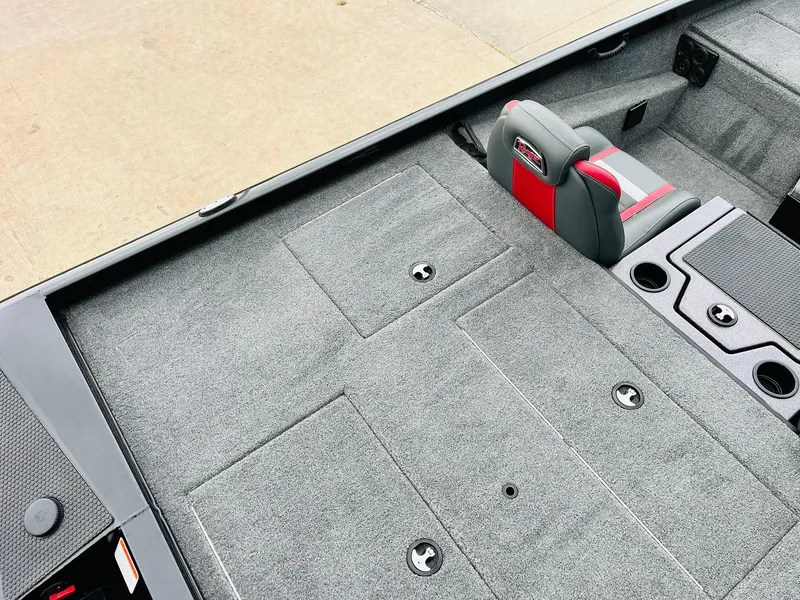 Slide: The Image of 2024 Ranger RT198P boat interior with gray carpet and red-accented seating. - 31