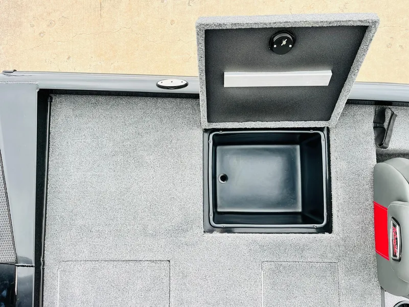 Slide: The Image of 2024 Ranger RT198P boat storage compartment with open lid, showcasing interior space. - 33