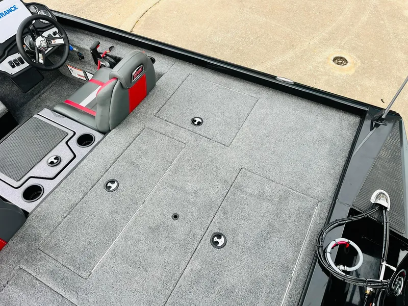 Slide: The Image of 2024 Ranger RT198P boat interior with gray carpet and red-accented seating. - 34
