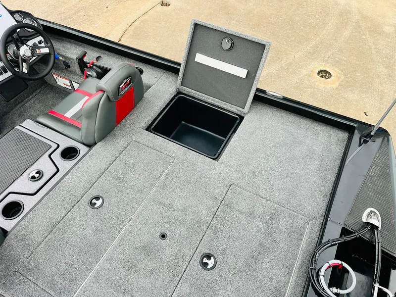 Slide: The Image of 2024 Ranger RT198P boat interior with open storage compartment and steering wheel. - 35