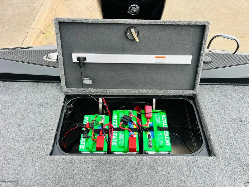 Slide: The Image of 2024 Ranger RT198P boat battery compartment with green batteries and wiring. - 37