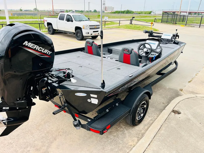 Slide: The Image of 2024 Ranger RT198P boat with Mercury engine, parked on a trailer in a lot. - 5