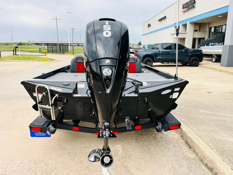 Slide: The Image of 2024 Ranger RT198P boat with powerful outboard motor, parked outside dealership. - 6