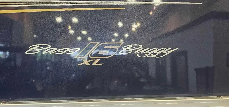 Slide: The Image of 2025 Sun Tracker Bass Buggy 16 XL Select logo with reflective surface. - 2